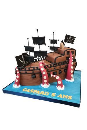A magnificent 3D sculpted birthday cake shaped like a brown pirate ship named the Black Pearl sailing on blue fondant waves, featuring tattered black sails, skull flags, and large pinkish-red tentacles wrapping around it.