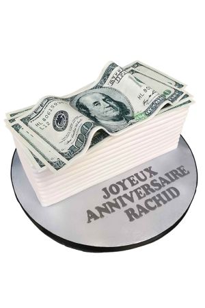 Gâteau d'anniversaire en forme de pile de billets de banque, avec des dollars américains dessus et un message inscrit dessus.