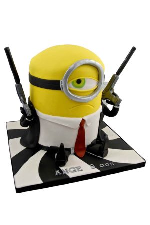 Custom 3D James Bond Minion birthday cake dressed in a suit with a red tie and holding gadget props, sitting on a black and white spiral cake board, handcrafted by The French Cake Company.