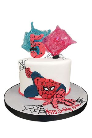 A white fondant birthday cake featuring a 2D Spiderman figure crawling on the side, decorated with black webs and a red number 5 on top.