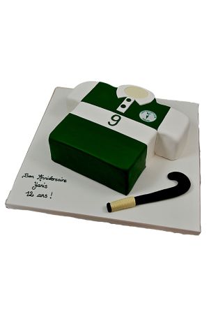Green and white 3D hockey jersey birthday cake with team crest, player number, and hockey stick by The French Cake Company