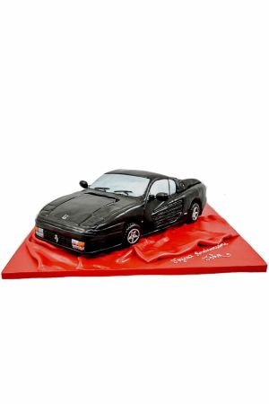  A detailed birthday cake shaped like a black Ferrari Testarossa.
