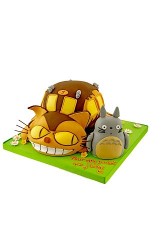 A birthday cake decorated to look like Totoro and the Cat Bus from the Studio Ghibli film.