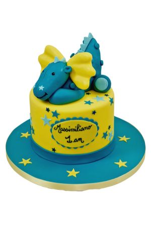 Gâteau du 1er anniversaire jaune lumineux à étoiles bleues surmonté d'un dragon 3D bleu turquoise et jaune Viktor de Noukie's réalisé par The French Cake Company