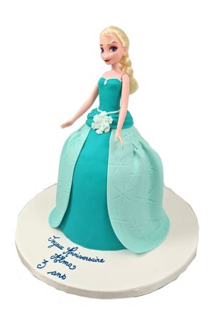 3D princess doll cake styled as Elsa from Frozen featuring a flowing turquoise and mint green fondant gown embossed with snowflakes, handcrafted by The French Cake Company.