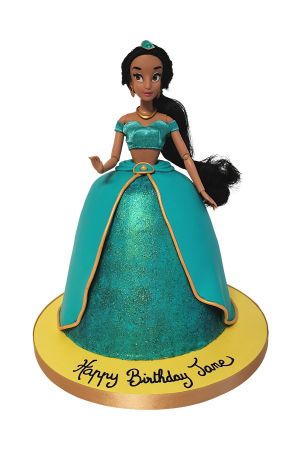 Custom Princess Jasmine doll birthday cake featuring a shimmering turquoise dome skirt with gold trimmings and a real fashion doll topper, handcrafted by The French Cake Company.