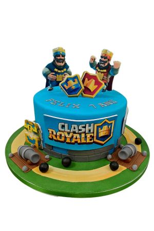 Vibrant blue round Clash Royale birthday cake featuring 3D king figures, game logo plaque, cannons, cannonballs, chest, and arena path base by The French Cake Company